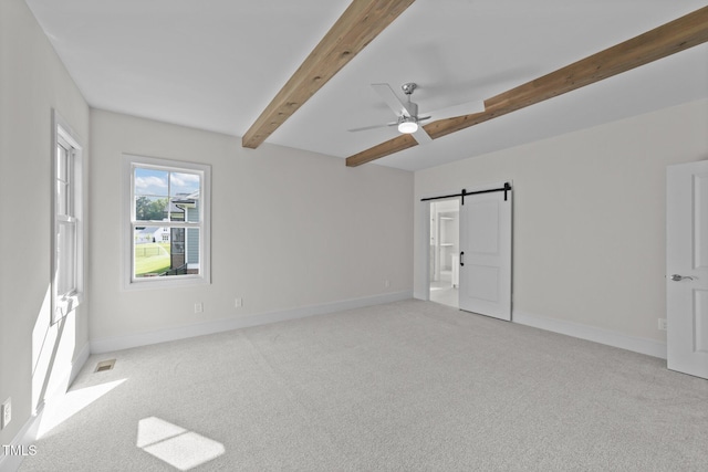 543 Allessandra Dr, Clayton, NC 27527 - unfurnished bedroom with beam ceiling, a barn door, light carpet, ceiling fan, and ensuite bath