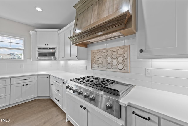 543 Allessandra Dr, Clayton, NC 27527 - kitchen featuring premium range hood, appliances with stainless steel finishes, light countertops, backsplash, and recessed lighting