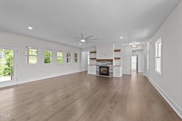 543 Allessandra Dr, Clayton, NC 27527 - unfurnished living room featuring healthy amount of natural light, dark wood finished floors, a fireplace, ceiling fan, and recessed lighting