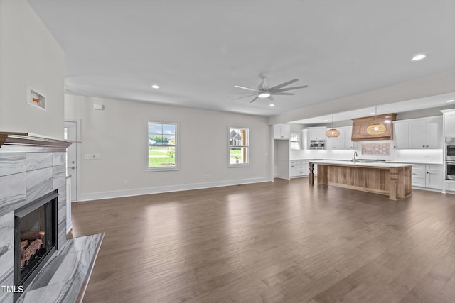 543 Allessandra Dr, Clayton, NC 27527 - unfurnished living room with ceiling fan, a fireplace, dark wood finished floors, and recessed lighting
