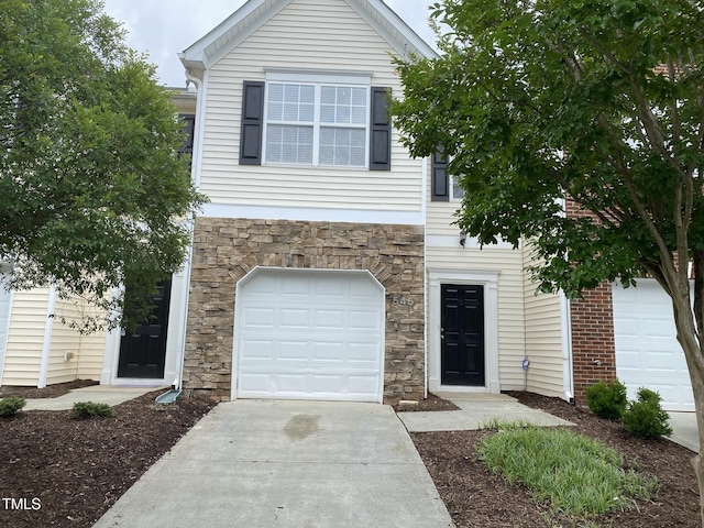 545 Writers Way, Morrisville, NC 27560 - view of front of home featuring stone siding, a garage, and driveway
