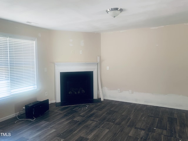 5908 Abbington Way, Raleigh, NC 27610 - unfurnished living room with wood finished floors and a fireplace with raised hearth