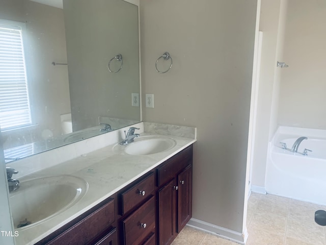 5908 Abbington Way, Raleigh, NC 27610 - bathroom featuring double vanity, tile patterned floors, and a bath