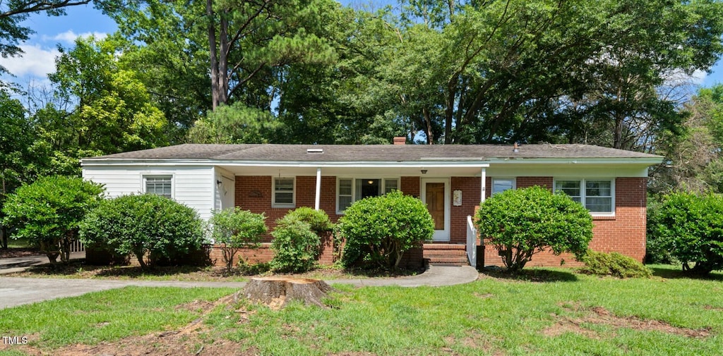 905 Aversboro Rd, Garner, NC 27529 - single story home featuring a front yard, brick siding, covered porch, and a chimney