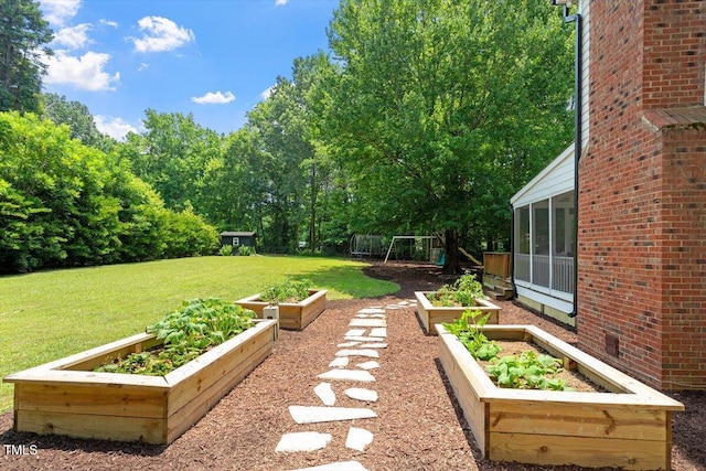 5833 Dahlberg Dr, Raleigh, NC 27603 - view of green lawn with a vegetable garden and a sunroom