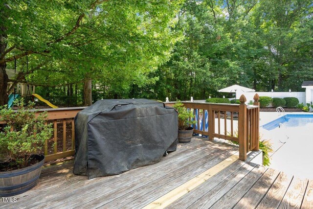 5833 Dahlberg Dr, Raleigh, NC 27603 - wooden terrace featuring a grill, a fenced backyard, and view of wooded area