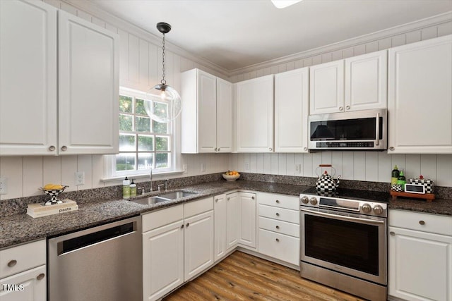 5833 Dahlberg Dr, Raleigh, NC 27603 - kitchen featuring appliances with stainless steel finishes, white cabinets, and light wood-style floors