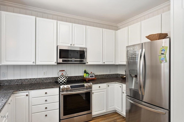5833 Dahlberg Dr, Raleigh, NC 27603 - kitchen with stainless steel appliances, white cabinets, crown molding, and wood finished floors
