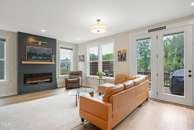 2055 Eva Pearl Dr, Apex, NC 27502 - living area with healthy amount of natural light, light wood-type flooring, a large fireplace, and recessed lighting