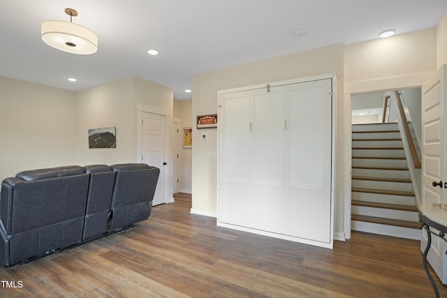 2055 Eva Pearl Dr, Apex, NC 27502 - living room with wood finished floors, stairs, and recessed lighting