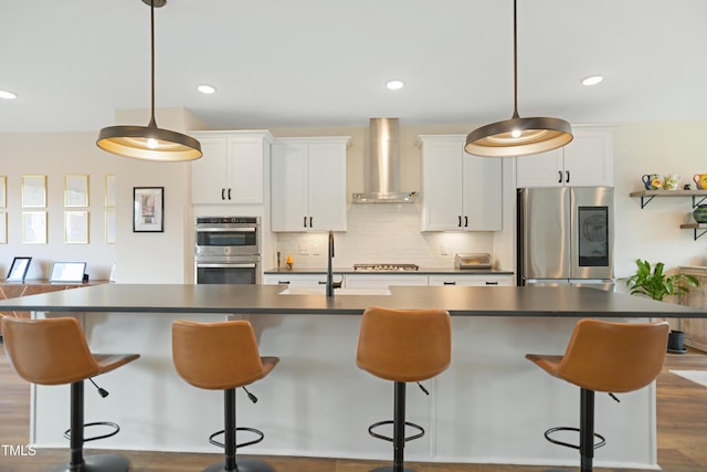 2055 Eva Pearl Dr, Apex, NC 27502 - kitchen featuring stainless steel appliances, wall chimney exhaust hood, dark countertops, and recessed lighting