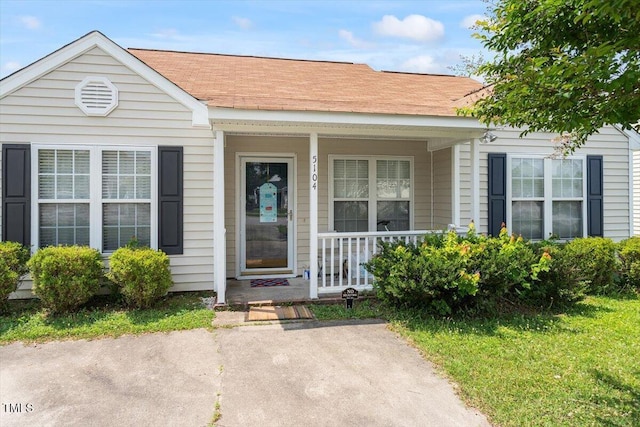 5104 Parkerwood Dr, Knightdale, NC 27545 - view of exterior entry with a porch and roof with shingles