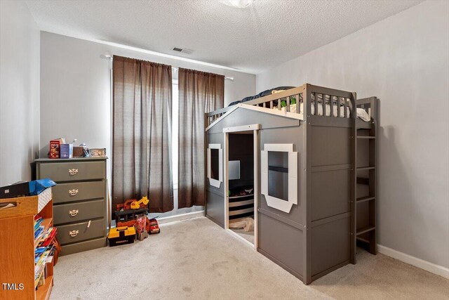 5104 Parkerwood Dr, Knightdale, NC 27545 - carpeted bedroom with a textured ceiling and baseboards