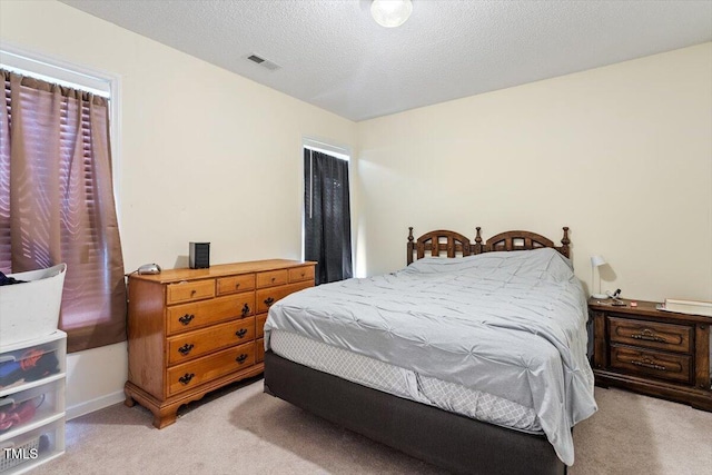 5104 Parkerwood Dr, Knightdale, NC 27545 - bedroom with light colored carpet and a textured ceiling