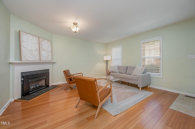 8 Mandy Ct, Durham, NC 27707 - living area featuring wood finished floors and a fireplace with raised hearth