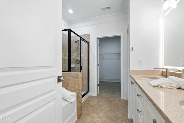9201 Wooden Rd, Raleigh, NC 27617 - full bath featuring ornamental molding, a shower stall, double vanity, a walk in closet, and tile patterned floors