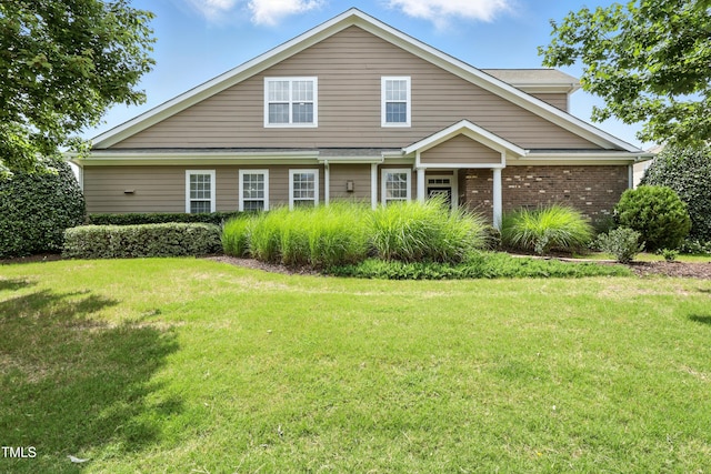 9201 Wooden Rd, Raleigh, NC 27617 - traditional-style home featuring a front lawn and brick siding