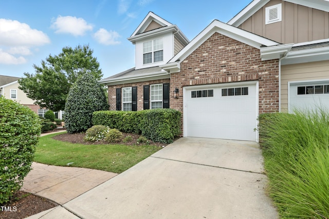 9201 Wooden Rd, Raleigh, NC 27617 - view of front of property with brick siding, driveway, board and batten siding, and an attached garage