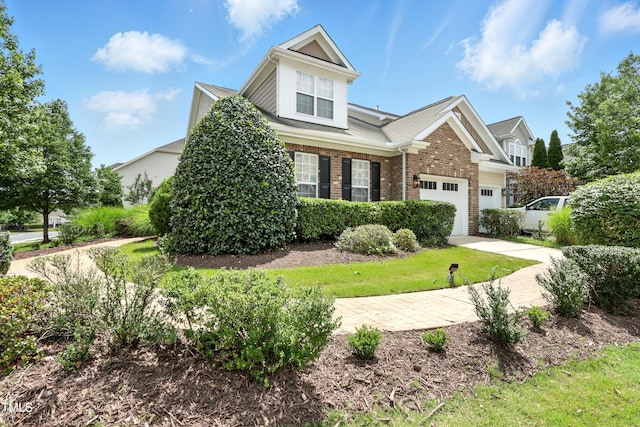 9201 Wooden Rd, Raleigh, NC 27617 - view of front of house with driveway, brick siding, and an attached garage