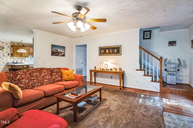 815 La Quinta Ln, Hope Mills, NC 28348 - living room with a ceiling fan, wood finished floors, stairway, ornamental molding, and a textured ceiling
