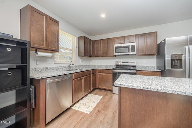 703 Corvette View Knl, Wendell, NC 27591 - kitchen with stainless steel appliances, light wood-type flooring, and light stone counters