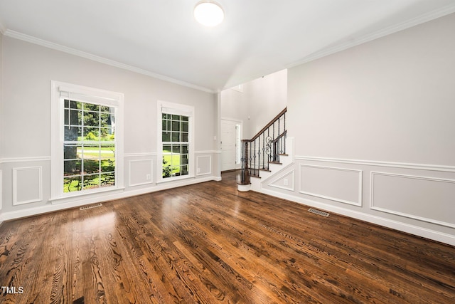 3811 Cottonwood Dr, Durham, NC 27705 - entrance foyer with ornamental molding, a decorative wall, stairs, dark wood finished floors, and a wainscoted wall