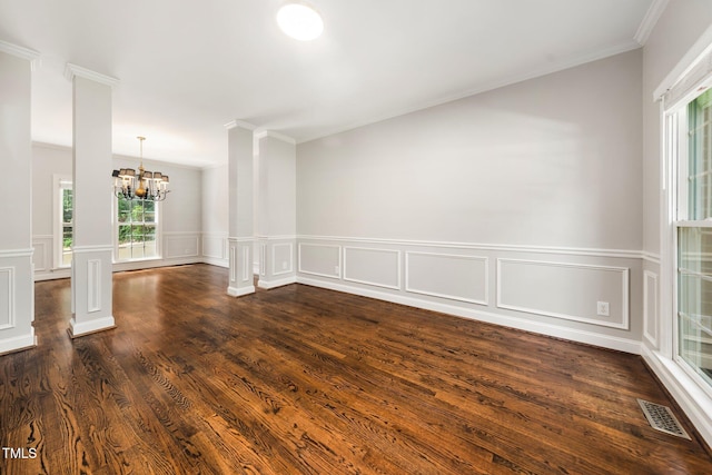 3811 Cottonwood Dr, Durham, NC 27705 - unfurnished room with a chandelier, ornamental molding, ornate columns, dark wood-style flooring, and a wainscoted wall