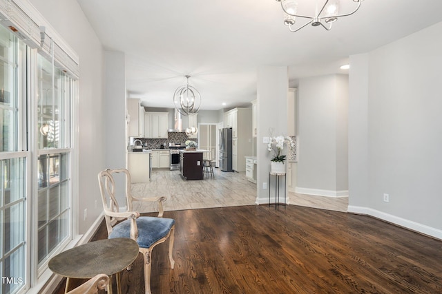3811 Cottonwood Dr, Durham, NC 27705 - dining area featuring a chandelier and light wood-type flooring