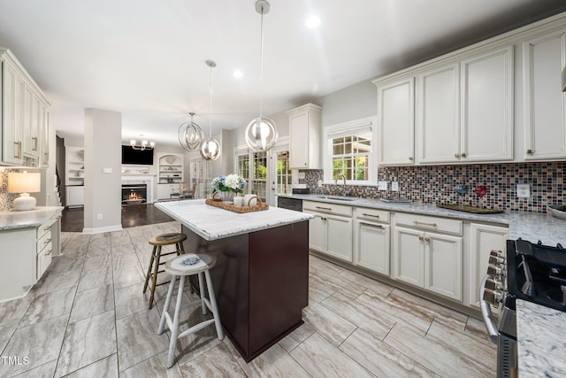 3811 Cottonwood Dr, Durham, NC 27705 - kitchen with stainless steel appliances, open floor plan, tasteful backsplash, and a kitchen island