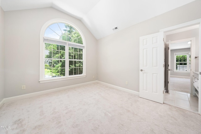 3811 Cottonwood Dr, Durham, NC 27705 - unfurnished bedroom featuring vaulted ceiling and carpet flooring
