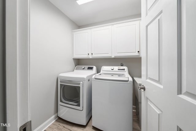 3811 Cottonwood Dr, Durham, NC 27705 - laundry area featuring washer and clothes dryer, cabinet space, and light wood finished floors