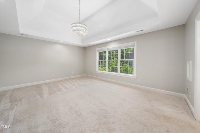 3811 Cottonwood Dr, Durham, NC 27705 - carpeted spare room with a raised ceiling, a chandelier, and recessed lighting