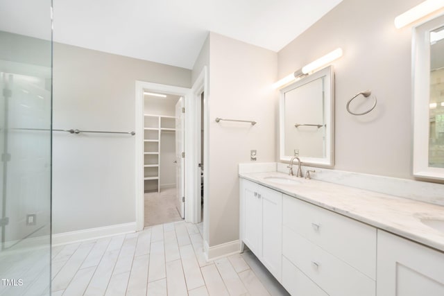 3811 Cottonwood Dr, Durham, NC 27705 - bathroom with double vanity, a spacious closet, and a shower with shower door