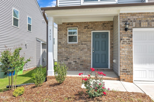 3505 Triad Ct, Raleigh, NC 27604 - view of exterior entry with brick siding, a garage, and a porch