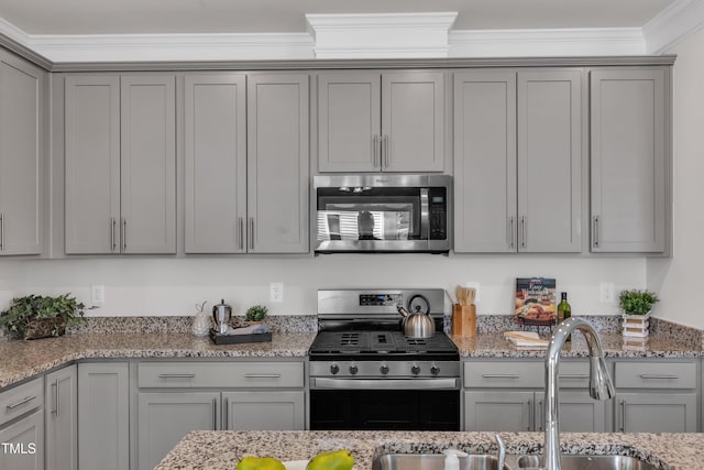 3505 Triad Ct, Raleigh, NC 27604 - kitchen with stainless steel appliances, gray cabinets, crown molding, and light stone counters