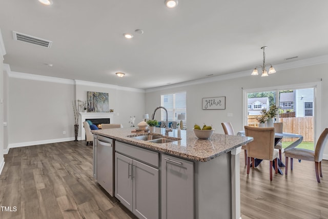 3505 Triad Ct, Raleigh, NC 27604 - kitchen with dishwasher, gray cabinetry, a lit fireplace, wood finished floors, and crown molding