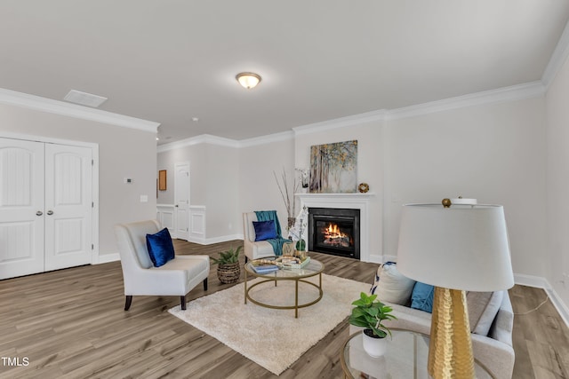 3505 Triad Ct, Raleigh, NC 27604 - living room with crown molding, a glass covered fireplace, and wood finished floors