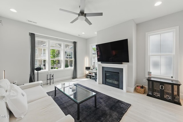 1008 Whistler St, Durham, NC 27713 - living room featuring a ceiling fan, wood finished floors, recessed lighting, and a glass covered fireplace