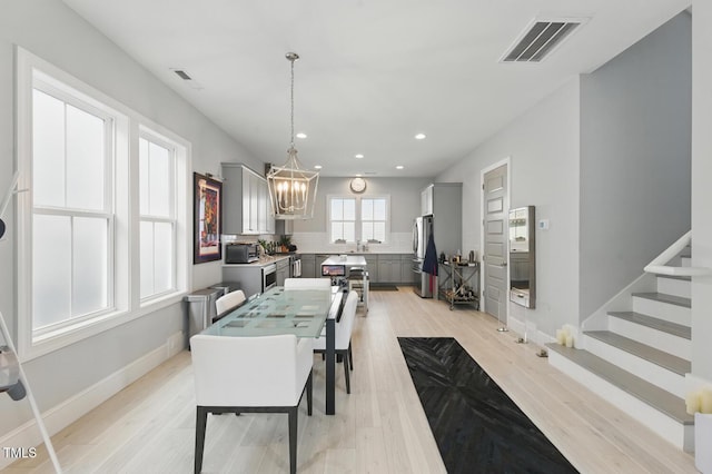1008 Whistler St, Durham, NC 27713 - dining space with a chandelier, light wood-style floors, recessed lighting, and stairway