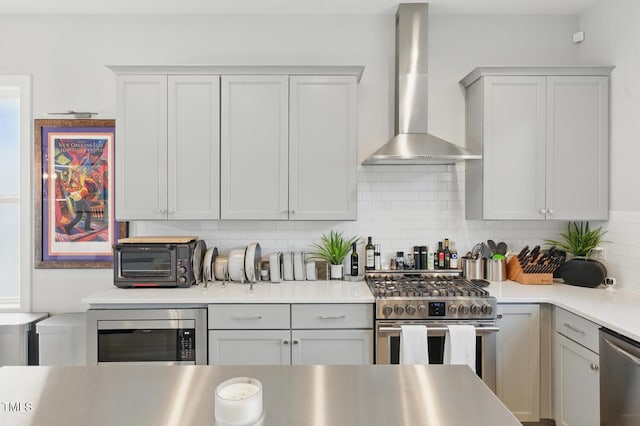 1008 Whistler St, Durham, NC 27713 - kitchen featuring wall chimney range hood, appliances with stainless steel finishes, backsplash, and light countertops