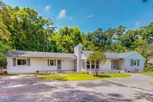 303 Winhaven St, Roxboro, NC 27573 - ranch-style house featuring a chimney and driveway