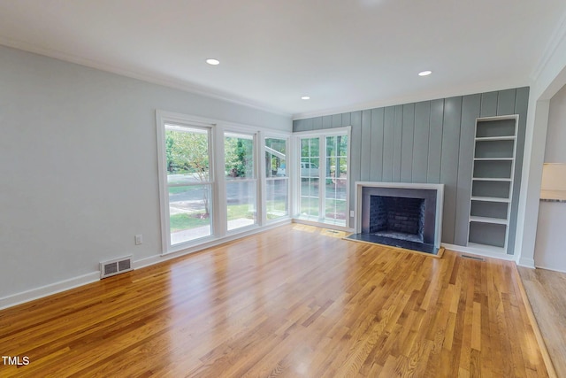 303 Winhaven St, Roxboro, NC 27573 - unfurnished living room featuring crown molding, plenty of natural light, wood finished floors, a large fireplace, and recessed lighting