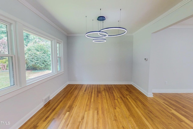 303 Winhaven St, Roxboro, NC 27573 - empty room featuring healthy amount of natural light, light wood-type flooring, and ornamental molding