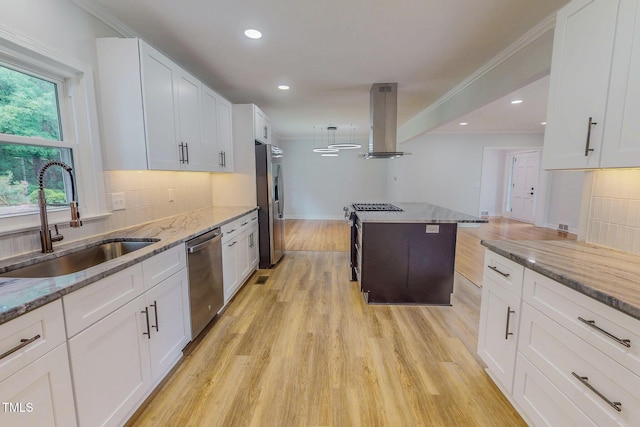 303 Winhaven St, Roxboro, NC 27573 - kitchen featuring island exhaust hood, stainless steel appliances, decorative backsplash, light wood-type flooring, and recessed lighting
