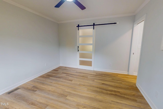 303 Winhaven St, Roxboro, NC 27573 - unfurnished room with a barn door, ceiling fan, crown molding, and wood finished floors