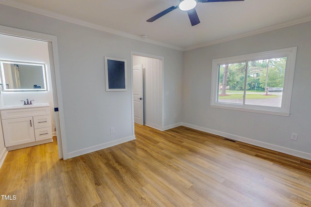 303 Winhaven St, Roxboro, NC 27573 - unfurnished bedroom featuring ornamental molding, light wood-type flooring, and connected bathroom