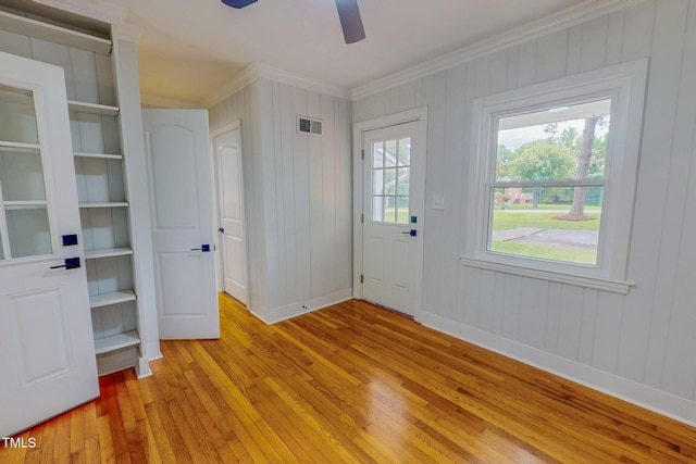 303 Winhaven St, Roxboro, NC 27573 - entrance foyer with crown molding, light wood finished floors, a ceiling fan, and wood walls