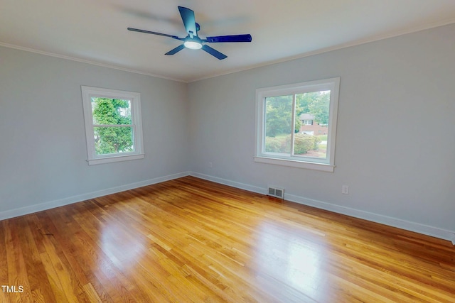 303 Winhaven St, Roxboro, NC 27573 - unfurnished room with healthy amount of natural light, crown molding, a ceiling fan, and light wood-type flooring