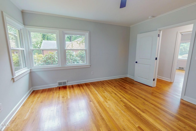 303 Winhaven St, Roxboro, NC 27573 - unfurnished room with healthy amount of natural light, light wood-style flooring, ornamental molding, and ceiling fan