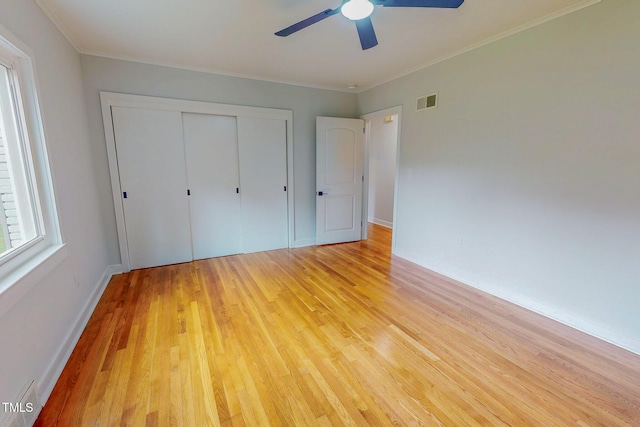 303 Winhaven St, Roxboro, NC 27573 - unfurnished bedroom featuring light wood-style floors, a closet, ornamental molding, and a ceiling fan
